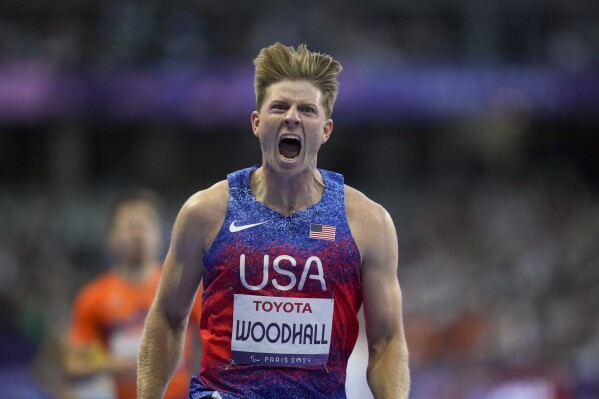 Hunter Woodhall from the U.S. celebrates after winning the men's 400 m. T62 final at the 2024 Paralympics, Friday, Sept. 6, 2024, in Paris, France. (AP Photo/Thibault Camus)
