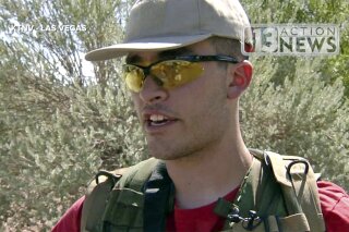 FILE - This Sept. 22, 2016, file photo taken from video from KTNV 13 Action News shows Conor Climo during an interview while walking a Las Vegas neighborhood, heavily armed. Climo a self-described white supremacist pleaded guilty Monday, Feb. 10, 2020, in Las Vegas to collecting materials and planning to bomb a local synagogue or office of the Anti-Defamation League, or shoot people at a fast food restaurant or a bar catering to LGBTQ customers. KTNV 13 Action News via AP, File)