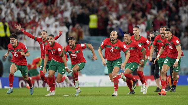 Morocco's players celebrate after the penalty shootout at the World Cup round of 16 soccer match between Morocco and Spain, at the Education City Stadium in Al Rayyan, Qatar, Tuesday, Dec. 6, 2022. (AP Photo/Luca Bruno)