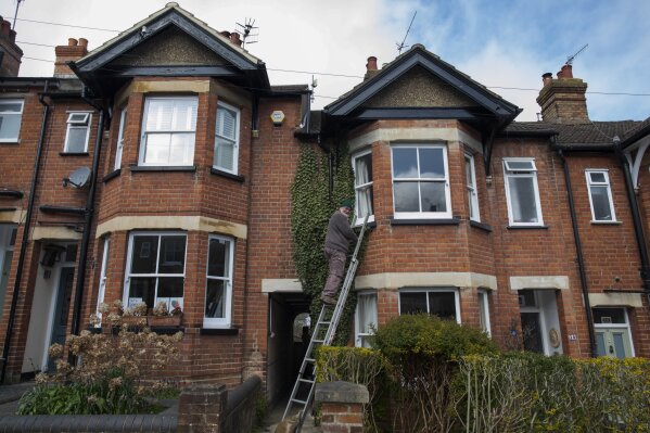 Bob works on his home during lockdown due to the coronavirus outbreak in Berkhamsted, England, Saturday, April 4, 2020. Bob Parsons and his wife Sue have lived there for 40 years. They have seen changes on the street but this is by far the strangest time they have lived through. (AP Photo/Elizabeth Dalziel)