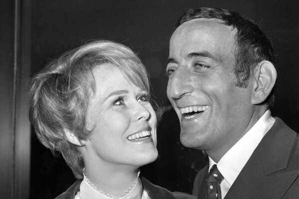 FILE - American singer Tony Bennett and 27-year-old Sandi Grant smile during the reception held at the Hilton Hotel, London on March 8, 1968, for Bennett who is in London for a concert tour. Bennett, the eminent and timeless stylist whose devotion to classic American songs and knack for creating new standards such as "I Left My Heart In San Francisco" graced a decadeslong career that brought him admirers from Frank Sinatra to Lady Gaga, died Friday, July 21, 2023. He was 96. (AP Photo/Bob Dear, File)