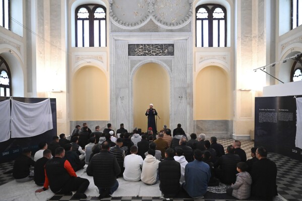 The imam leads the morning prayers at the historic Yeni Cami, or New Mosque, in the port city of Thessaloniki, northern Greece, Wednesday, April 10, 2024. Eid prayers were held in the historic former mosque in northern Greece for the first time in 100 years. (AP Photo/Giannis Papanikos)