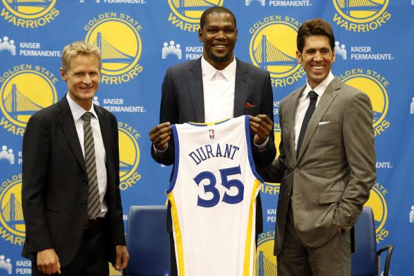 FILE - Golden State Warriors' newest player Kevin Durant, center, joins head coach Steve Kerr, left and general manager Bob Myers during a news conference at the NBA basketball team's practice facility, July 7, 2016, in Oakland, Calif. Durant decided to leave the Oklahoma City Thunder and join the Golden State Warriors. (AP Photo/Beck Diefenbach, File)
