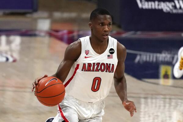FILE - In this Jan. 7, 2021, file photo, Arizona guard Bennedict Mathurin brings the ball up during the first half of the team's NCAA college basketball game against Southern California in Tucson, Ariz. Mathurin is one of several key returning players who should help ease Tommy Lloyd’s transition to head coach for the first time. Mathurin averaged 10.8 points as a freshman last season. (AP Photo/Rick Scuteri, File)