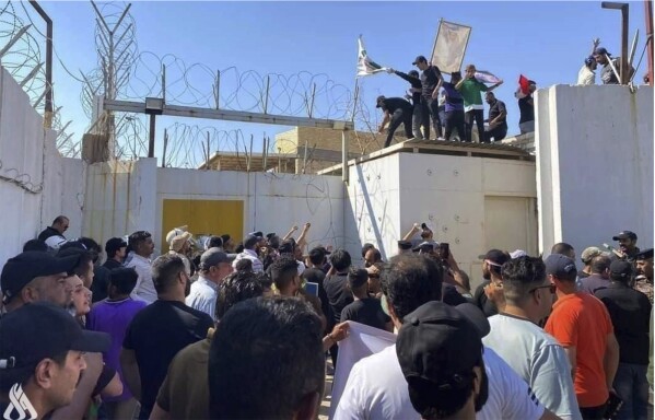 In this photo provided by the Iraqi News Agency, followers of the influential Iraqi Shiite cleric and political leader Muqtada Sadr storm the Swedish embassy in Baghdad, Iraq, Thursday, June 29, 2023, in protest of the burning of a Quran in Sweden. An Iraqi security official has said the Swedish embassy was evacuated by security forces after the protesters breached the building. (Iraqi News Agency via AP)