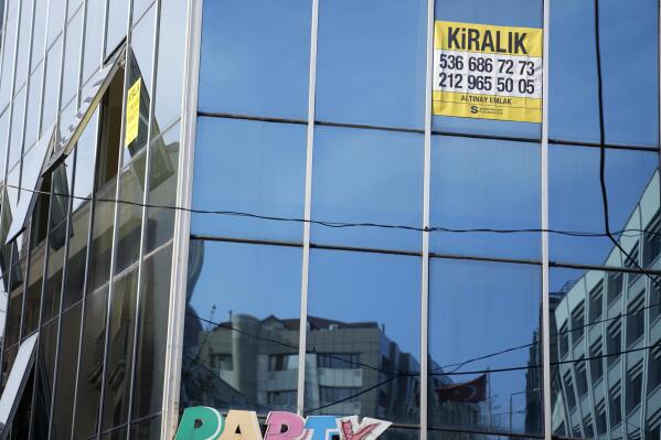 A poster reading 'For rent' in Turkish, pasted on a building in Istanbul, Tuesday, Dec. 8, 2022. Economic turmoil driven by inflation of 85% has plunged Turkey into one of its worst property crises. Skyrocketing prices have made finding affordable housing to rent or buy an uphill battle for many, especially for millions earning minimum wage who also struggle to cover food and energy costs. Increasing construction costs and inflation have pushed up housing prices globally. (AP Photo/Khalil Hamra)