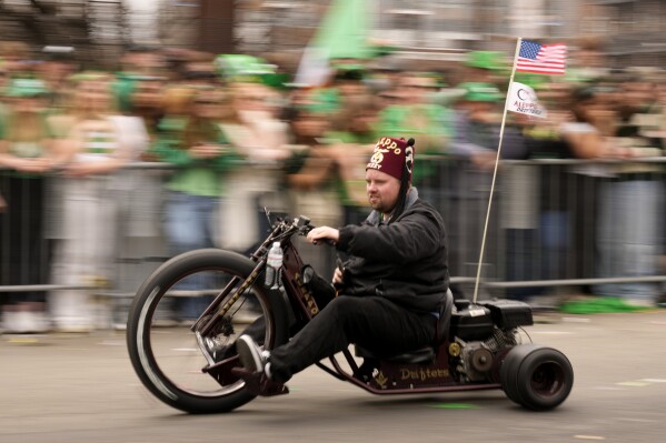 A Shriner motors by the crowd during the St. Patrick's Day parade, Sunday, March 16, 2025, in Boston, Mass. (AP Photo/Robert F. Bukaty)