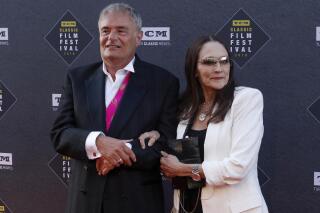 FILE - Leonard Whiting, left, and Olivia Hussey arrive at the screening of "The Producers" at the 2018 TCM Classic Film Festival Opening Night at the TCL Chinese Theatre on April 26, 2018, in Los Angeles. A Los Angeles County judge on Thursday, May 25, 2023, said she will dismiss a lawsuit that the stars, Whiting and Hussey, of 1968's “Romeo and Juliet" filed over the film's nude scene, which they said involved them being subjected to fraud, and sexual abuse and harassment when they were in their teens. (Photo by Willy Sanjuan/Invision/AP, File)