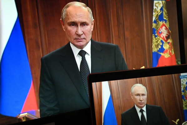 FILE - Russian President Vladimir Putin is seen on monitors as he addresses the nation after Yevgeny Prigozhin, the owner of the Wagner Group military company, called for armed rebellion and reached the southern city of Rostov-on-Don with his troops, in Moscow, Russia, Saturday, June 24, 2023. (Pavel Bednyakov, Sputnik, Kremlin Pool Photo via AP, File)