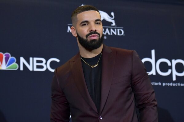 FILE - This May 1, 2019 file photo shows Drake at the Billboard Music Awards in Las Vegas. Earning his 21st No. 1 hit on Billboard's R&B/Hip-Hop songs chart, Drake has bested a record previously held by icons Aretha Franklin and Stevie Wonder. Drake's “Laugh Now Cry Later," featuring rapper Lil Durk, reached the No. 1 spot on the chart this week. Wonder and Franklin, who died in 2018, each have had 20 songs top the chart. (Photo by Richard Shotwell/Invision/AP, File)