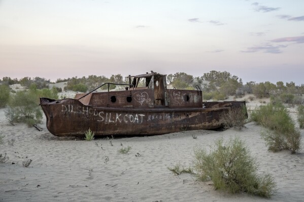 A rusting ship sits in a dried-up area of the Aral Sea in Muynak, Uzbekistan, Sunday, June 25, 2023. Decades ago, deep blue and filled with fish, it was one of the world's largest inland bodies of water. It's shrunk to less than a quarter of its former size. (APPhoto/Ebrahim Noroozi)