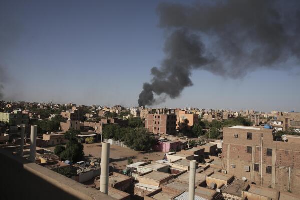 Smoke is seen in Khartoum, Sudan, Wednesday, April 19, 2023. Terrified Sudanese are fleeing their homes in the capital Khartoum, witnesses say, after an internationally brokered cease-fire failed and rival forces battled in the capital for a fifth day. (AP Photo/Marwan Ali)