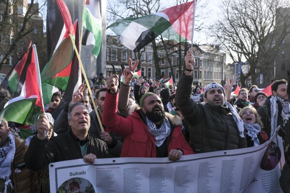 Pro-Palestinian activists react near the International Court of Justice, or World Court, in The Hague, Netherlands, Friday, Jan. 26, 2024. The United Nations' top court has decided not to throw out genocide charges against Israel for its military offensive in Gaza. That is part of a preliminary decision in a case that goes to the core of one of the world's most intractable conflicts. (AP Photo/Patrick Post)