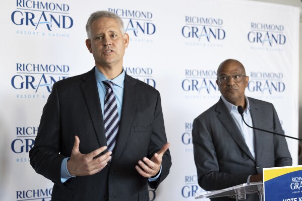 William Carstanjen, CEO of Churchill Downs, Inc., speaks about a resort, casino, and entertainment complex during a press conference as Alfred Liggins, III, CEO of Urban One, Inc., listens on Thursday, Aug. 31, 2023 in Richmond, Va. (Mike Kropf/Richmond Times-Dispatch via AP)