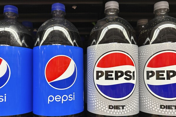 FILE - Plastic bottles of Pepsi are displayed at a grocery store in New York on Nov. 15, 2023. Before inflation began heating up, a 2-liter bottle of soda it cost an average of $1.67 in supermarkets across America. Three years later it is going for $2.25 – a 35% increase.(AP Photo/Ted Shaffrey, File)
