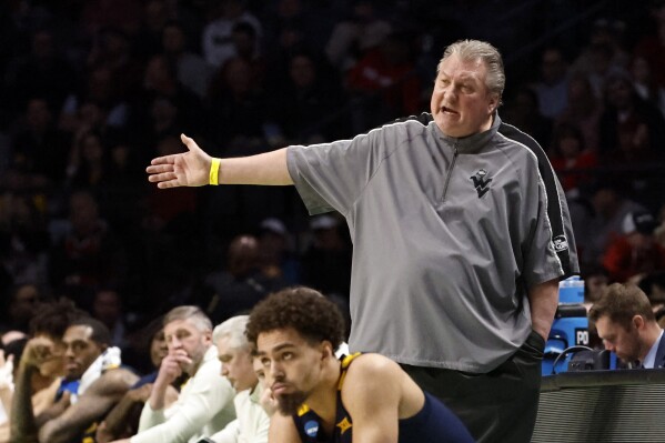 FILE - West Virginia head coach Bob Huggins reacts to a call in the second half of a first-round college basketball game against Maryland in the NCAA Tournament in Birmingham, Ala., March 16, 2023. In a statement released Monday, July 10, Huggins said he checked into a rehabilitation facility following a drunken driving arrest and disputes that he resigned at West Virginia, accusing the university of releasing a “false statement” about him stepping down. (AP Photo/Butch Dill, File)
