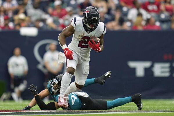 Houston Texans running back Mark Ingram II (2) rushes for a first down as Jacksonville Jaguars safety Andrew Wingard defends during the second half of an NFL football game Sunday, Sept. 12, 2021, in Houston. (AP Photo/Sam Craft)