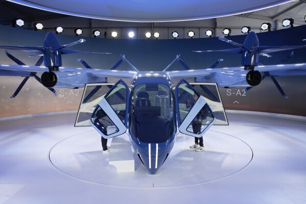 A person looks at the Supernal S-A2 passenger electric VOTL aircraft at the Supernal booth during the CES tech show Wednesday, Jan. 10, 2024, in Las Vegas. Supernal is a part of the Hyundai Motor Group. (AP Photo/John Locher)