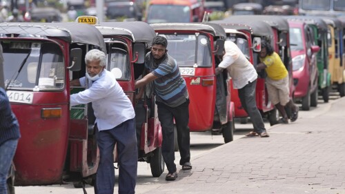 FILE - Auto rickshaw drivers line up to buy gas near a fuel station in Colombo, Sri Lanka, Wednesday, April 13, 2022. Sri Lanka’s Cabinet of ministers on Wednesday, June 28, 2023, approved a program to restructure staggering domestic debt as the island nation struggles to come out from an unprecedented economic crisis that has engulfed it since last year. (AP Photo/Eranga Jayawardena, File)