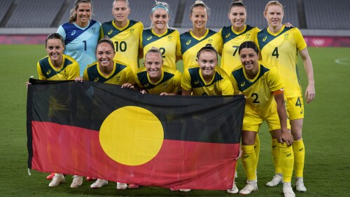 FILE - Australia players pose for a group photo with the Aboriginal flag prior to women's soccer match against New Zealand at the 2020 Summer Olympics, July 21, 2021, in Tokyo. FIFA President Gianni Infantino confirmed the decision on Friday, July 7, 2023, that First Nations flags will be flown at Women's World Cup stadiums in Australia and New Zealand after soccer's world governing body agreed to make exceptions to the usually tight FIFA match day regulations for tournament venues. (AP Photo/Ricardo Mazalan, File)