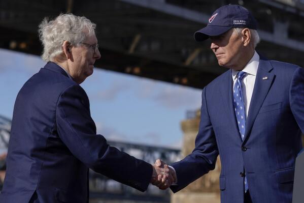 FILE - President Joe Biden shakes hands with Senate Minority Leader Mitch McConnell of Ky., after speaking about his infrastructure agenda under the Clay Wade Bailey Bridge, Jan. 4, 2023, in Covington, Ky. By temperament and manner, Joe Biden and Mitch McConnell are decidedly mismatched. But as the days of divided government under Biden begin, their long relationship will become even more vital. McConnell’s experience in cutting deals and the political capital he retains among his members could leave him much freer to negotiate thorny matters with the White House. (AP Photo/Patrick Semansky, File)
