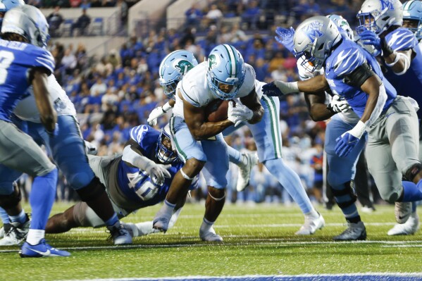Tulane's Makhi Hughes (21) runs the ball in for a touchdown against Memphis during an NCAA college football game Friday, Oct. 13, 2023, in Memphis, Tenn. (Chris Day/The Commercial Appeal via AP)