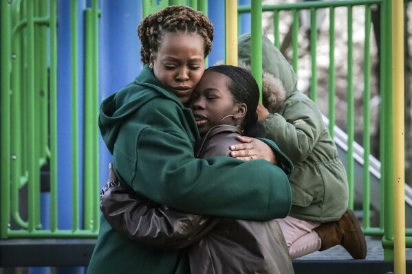 Derry Oliver, 17, right, hugs her mother, also Derry Oliver, during a visit to a playground near home, Friday, Feb. 9, 2024, in New York. During the COVID-19 pandemic, the younger Oliver embraced therapy as she struggled with the isolation of remote learning, even as her mother pushed back. (APPhoto/Bebeto Matthews)
