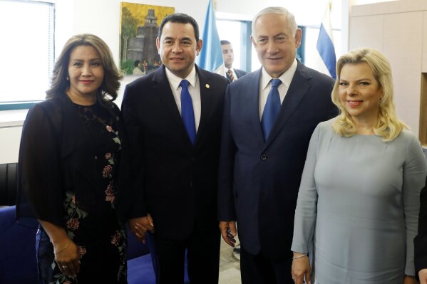 
              Guatemala President Jimmy Morales, center left, and his wife Hilda Patricia Marroquin, left, pose for the media with Israel Prime Minister Benjamin Netanyahu and his wife Sara ahead of the dedication ceremony of the Guatemala Embassy in Jerusalem, Israel, Wednesday May 16, 2018. (Ronen Zvulun/Pool via AP)
            