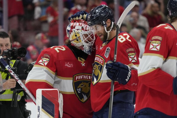 Florida Panthers goaltender Sergei Bobrovsky (72) and center Kevin Stenlund (82) celebrate at the end of the third period of Game 2 of the NHL hockey Stanley Cup Finals, Monday, June 10, 2024, in Sunrise, Fla. (AP Photo/Wilfredo Lee)
