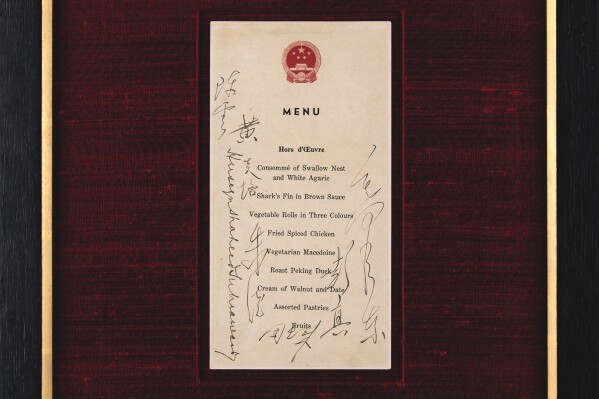 This photo provided by RR Auction shows an official menu for a state banquet signed by former Chinese leader Mao Zedong that has been auctioned for $275,000. (RR Auction via AP)