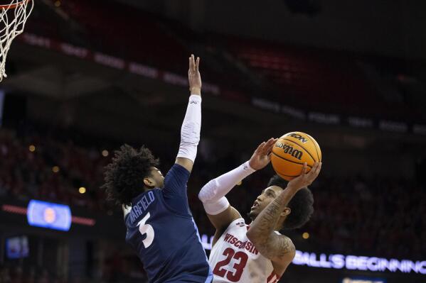 Wisconsin guard Chucky Hepburn (23) shoots the ball against Liberty guard Isiah Warfield (3) in the second half of the second round NCAA college basketball game in the National Invitational Tournament at the Kohl Center in Madison, Wis., Sunday, March 19, 2023. (Samantha Madar/Wisconsin State Journal via AP)