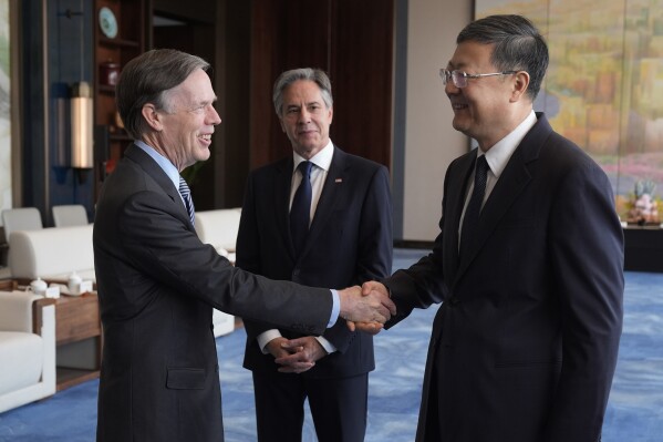 U.S. Secretary of State Antony Blinken, center, watches U.S. Ambassador to China Nicholas Burns, left, shake hands with Shanghai Party Secretary Chen Jining at the Grand Halls, Thursday, April 25, 2024, in Shanghai, China. (AP Photo/Mark Schiefelbein, Pool)