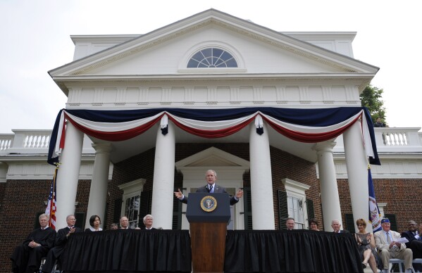 FILE - President George W. Bush gestures during remarks at Monticello's 46th annual Independence Day celebration and naturalization ceremony in Charlottesville, Va., July 4, 2008. (AP Photo/Evan Vucci, File)
