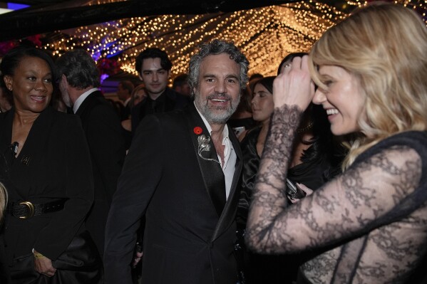 Mark Ruffalo, center, and Sunrise Coigney attend the Governors Ball after the Oscars on Sunday, March 10, 2024, at the Dolby Theatre in Los Angeles. (AP Photo/John Locher)