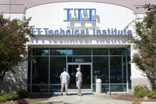 FILE - In this Sept. 6, 2016, file photo students find the doors locked to the ITT Technical Institute campus in Rancho Cordova, Calif. The U.S. Education Department announced Thursday, Aug. 26, 2021, it will forgive student debt for more than 100,000 borrowers who attended the now-defunct ITT Technical Institute chain but left before graduating. (AP Photo/Rich Pedroncelli, File)