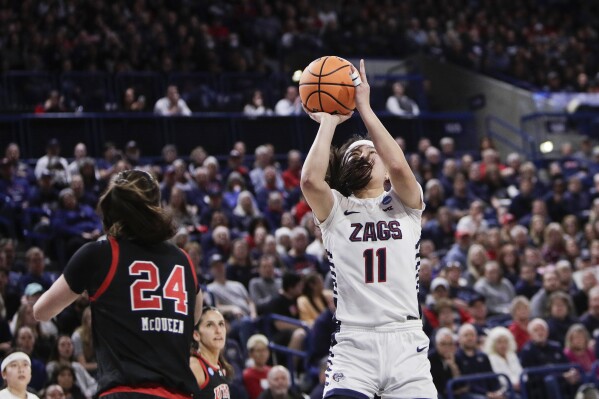 Gonzaga guard Kayleigh Truong (11) shoots next to Utah guard Kennady McQueen (24) during the first half of a second-round college basketball game in the NCAA Tournament in Spokane, Wash., Monday, March 25, 2024. (AP Photo/Young Kwak)