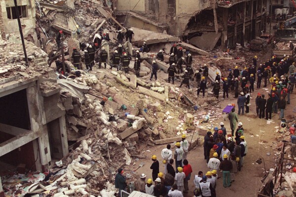 FILE - Firefighters and rescue workers search through the rubble of the Buenos Aires Jewish Community Center after a car bomb rocked the building on July 18, 1994. It was the worst bombing attack on civilians in Argentina’s history, killing 85 and injuring 300. It came two years after a 1992 bombing on the Israeli embassy in Argentina, killing 29. (AP Photo/Alejandro Pagni, File)