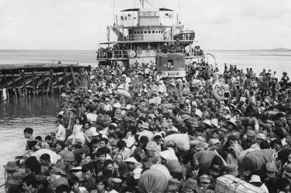 FILE - Refugees crowd a naval vessel docked at Vung Tau, a coastal town near Saigon on April 9, 1975. The Immigration and Nationality Act of 1952 lets the president grant entry for humanitarian reasons and matters of public interest. Previous administrations have admitted large numbers of Hungarians, Vietnamese and Cubans. (AP Photo/Kim Ki Sam, File)