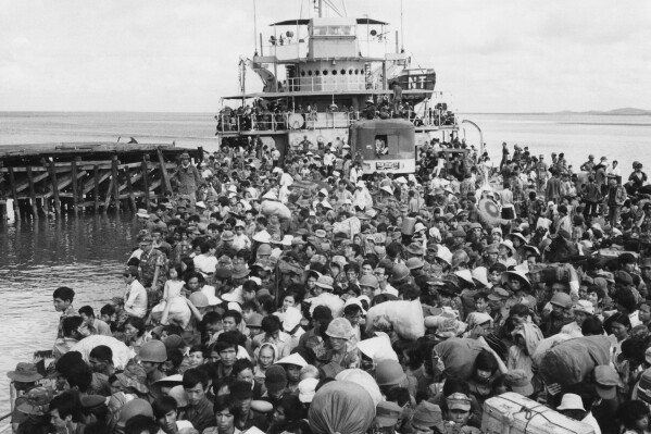 FILE - Refugees crowd a naval vessel docked at Vung Tau, a coastal town near Saigon on April 9, 1975. The Immigration and Nationality Act of 1952 lets the president grant entry for humanitarian reasons and matters of public interest. Previous administrations have admitted large numbers of Hungarians, Vietnamese and Cubans. (AP Photo/Kim Ki Sam, File)