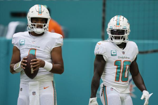 Miami Dolphins quarterback Tua Tagovailoa (1) and wide receiver Tyreek Hill (10) warm up before an NFL football game against the New England Patriots, Sunday, Sept. 11, 2022, in Miami Gardens, Fla. (AP Photo/Rebecca Blackwell)