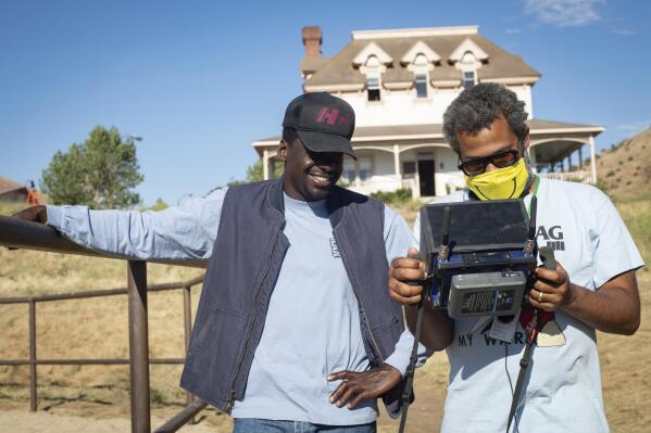 This image released by Universal Pictures shows actor Daniel Kaluuya, left, and writer/director Jordan Peele on the set of "Nope."  (Glen Wilson/Universal Pictures via AP)