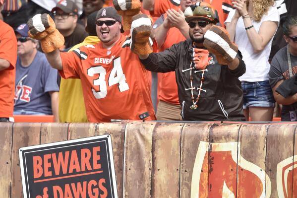 FILE - Fans cheer in the Dawg Pound end zone seats during an NFL football game between the Cleveland Browns and the New York Jets, Sunday, Oct. 8, 2017, in Cleveland. Nine home teams are underdogs in Week 3. Behind the Dawg Pound, the Cleveland Browns aren’t among them. The Browns host the Pittsburgh Steelers on Thursday night to kick off a week featuring more road favorites than home. (AP Photo/David Richard, File)