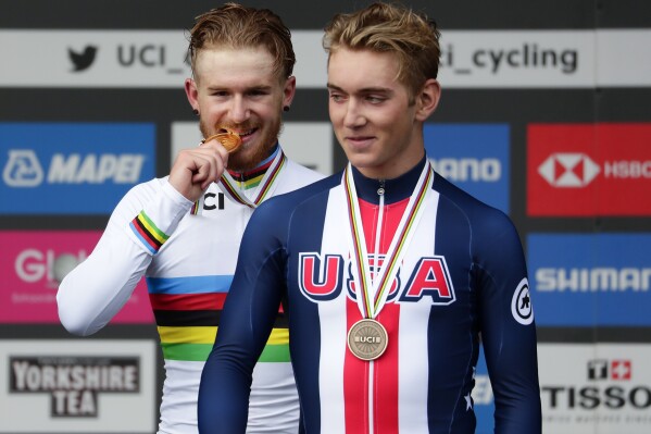 FILE - Bronze medal winner Magnus Sheffield, right, poses during the podium ceremony as fellow U.S. cyclist, Quinn Simmons, who won gold, looks on at the road cycling World Championships in Harrogate, England, Thursday, Sept. 26, 2019. Sheffield and Matteo Jorgenson will join Brandon McNulty on the U.S. cycling team for the Paris Olympics. Together, the trio could be the best chance for an American to win a road race medal since Alexi Grewal took gold 40 years ago. (AP Photo/Manu Fernandez, File)