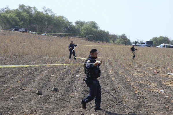 Police tape off the area where volunteers said they have found a clandestine crematorium in Tlahuac, on the edge of Mexico City, Wednesday, May 1, 2024. Ceci Flores, a leader of one of the groups of so-called "searching mothers" from northern Mexico, announced late Tuesday that her team had found bones around clandestine burial pits and ID cards, and prosecutors said they were investigating to determine the nature of the remains found. (AP Photo/Ginnette Riquelme)