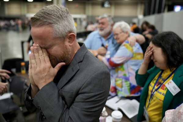 CORRECTS ID: Rev. Andy Oliver, Pastor of Allendale UMC in St. Petersburg, Florida, reacts after an approval vote at the United Methodist Church General Conference Wednesday, May 1, 2024, in Charlotte, N.C. United Methodist delegates repealed their church’s longstanding ban on LGBTQ clergy with no debate on Wednesday, removing a rule forbidding “self-avowed practicing homosexuals” from being ordained or appointed as ministers. (AP Photo/Chris Carlson)
