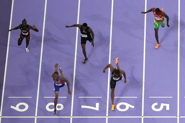 Quincy Hall, of the United States, lane eight, wins the men's 400-meter final at the 2024 Summer Olympics, Wednesday, Aug. 7, 2024, in Saint-Denis, France. (AP Photo/David J. Phillip)
