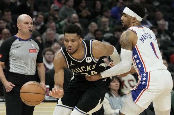 Philadelphia 76ers' KJ Martin fouls Milwaukee Bucks' Giannis Antetokounmpo during the second half of an NBA basketball game Thursday, March 14, 2024, in Milwaukee. The Bucks won 114-105. (AP Photo/Morry Gash)