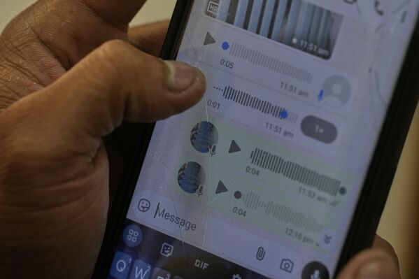 A Rohingya refugee who has not been identified due to safety concerns, shows his conversation details on WhatsApp with his family members in Myanmar as he talks to The Associated Press in New Delhi, India, Friday, May 16, 2025. (AP Photo/Manish Swarup)