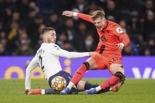 Tottenham Hotspur's Matt Doherty, left, and Norwich City's Brandon Williams battle for the ball during the English Premier League soccer match between Tottenham Hotspur and Norwich City, at Tottenham Hotspur Stadium, London, Sunday, Dec. 5, 2021. (Adam Davy/PA via AP)