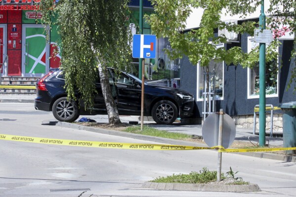 Car is seen on the site of a shooting, in the small Bosnian town of Gradacac, Bosnia, Friday, Aug. 11, 2023. Police in Bosnia launched on Friday a major chase for a man who claimed to have shot and killed his wife while broadcasting it live on Instagram. (AP Photo)